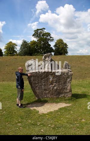 Mann berühren einen Stein bei Avebury Stone Circle Wiltshire Stockfoto