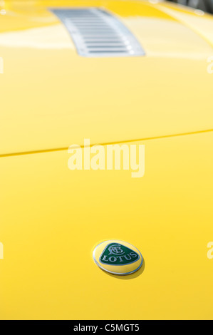 Lotus-Sportwagen-Abzeichen auf eine gelbe Haube Stockfoto