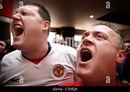 Manchester Utd inoffizielle Songschreiber Peter Boyle führt das Singen von Manchester United Fans in der Bischof Blaize Kneipe. Stockfoto