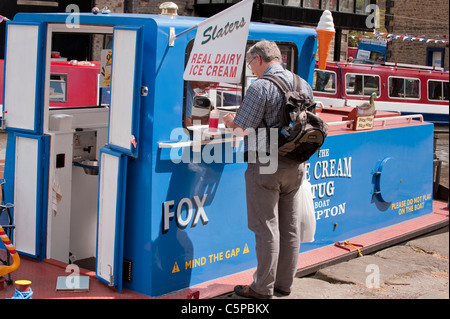 1 Mann serviert und verkauft Eis an männliche Kunden stehen am Schalter des umgebauten Schlepper 'Fox' - Leeds Liverpool Canal, Skipton, Yorkshire, GB, UK Stockfoto