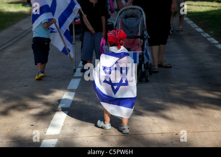 Junge verpackt mit der israelischen Nationalflagge wandern während der Kinderwagen März in Tel Aviv hohe Kosten für die Erziehung der Kinder in Israel zu protestieren Stockfoto