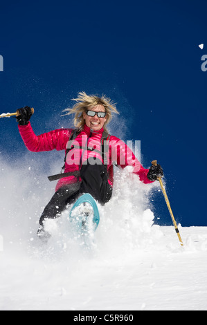 Eine Frau, die Spaß Schneeschuhwanderungen durch tief frischen Pulverschnee. Stockfoto