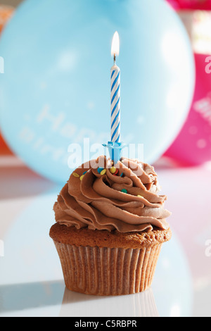 Nahaufnahme von Schokolade Buttercreme Cupcake mit Geburtstag Kerze Stockfoto