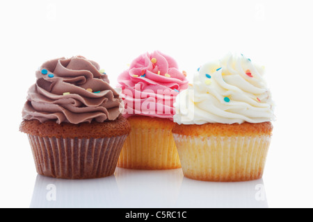 Nahaufnahme von Erdbeere, Vanille und Schokolade Buttercreme Cupcakes vor weißem Hintergrund Stockfoto