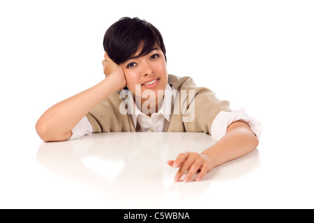 Lächelnd gemischt Rennen junge Erwachsene weibliche sitzen am weißen Tisch, Isolated on White Background. Stockfoto