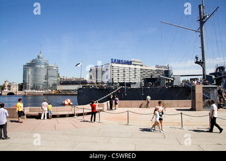 Russische Kreuzer Aurora, ehemalige Kriegsschiff jetzt ein Museumsschiff, mit Samsung Gebäude im Hintergrund, St Petersburg, Russland Stockfoto