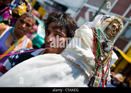 Ein mexikanischer Anhänger der Santa Muerte (Tod der Heiligen) hält eine heilige Statue während der Wallfahrt in Tepito, Mexico City, Mexiko. Stockfoto