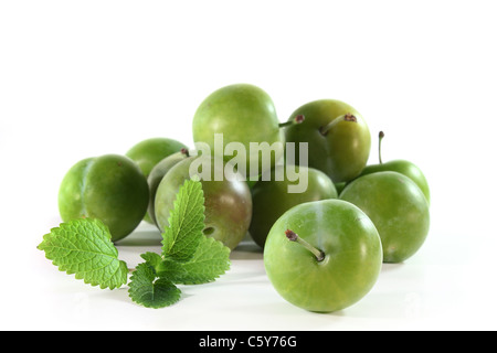 frische grüne Pflaumen auf weißem Hintergrund Stockfoto