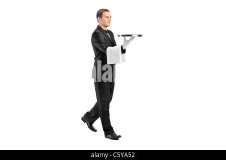 Voller Länge Porträt eines jungen Butler mit Fliege mit einem Tablett Stockfoto