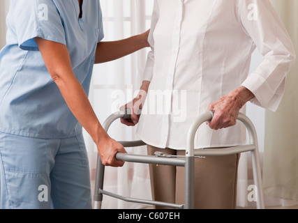 USA, Illinois, Metamora, Krankenschwester helfen senior Frau mit Walker, Mittelteil Stockfoto