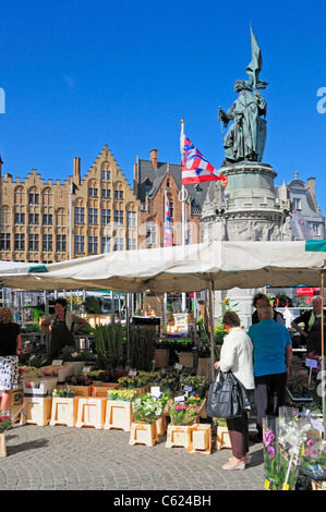 Brügge / Brugge, Flandern, Belgien. Markt - Marktplatz. Blumenmarkt Stände; Statue von Pieter de Coninck + Jan Breidel Stockfoto