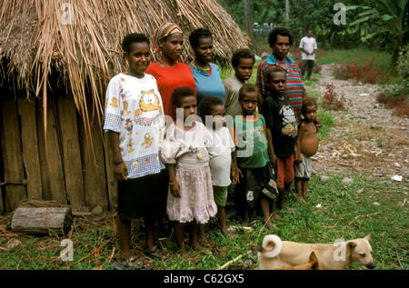 Im Umsiedlungsdorf Kwamki Lama, außerhalb von Timika, lebt eine große Familiengruppe von Dani aus dem Hochland in ihren traditionellen bienenstockförmigen Strohhütten. West Papua, Indonesien Stockfoto