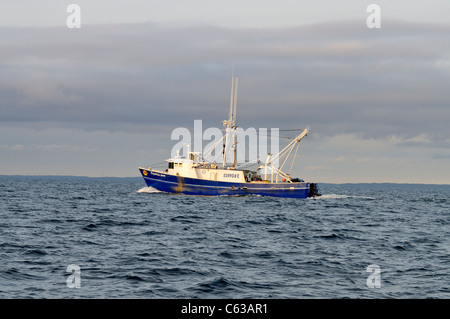 Blick auf den Hafen Seite blau geschälten Fischerboot vor der Küste von Cape Cod mit Sturm Wolken im Himmel. USA Stockfoto