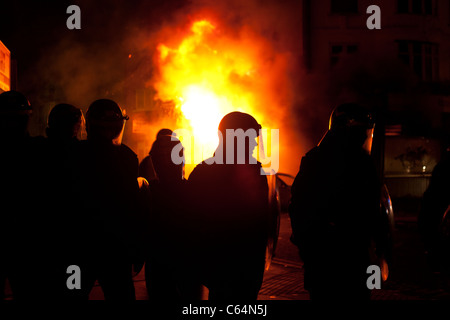 Polizei in Croydon vor einem brennenden Gebäude während der Unruhen von August 2011 Stockfoto