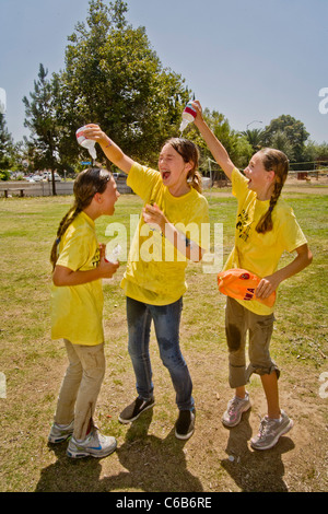 Teenie Mädchen Gießen Sie kaltes Wasser über einander an einem heißen Nachmittag in Orange, Kalifornien. Stockfoto