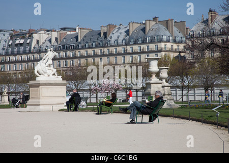 Menschen sitzen entspannen in Stühlen in Wintersonne am Jardin des Tuileries, Paris, Frankreich Stockfoto