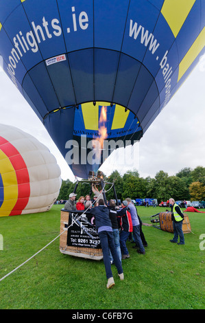 Menschen, die einen Hotair Ballon gedrückt, bevor es startet Stockfoto