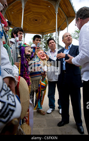 Präsident Felipe Calderon und Peter Greenberg mit kostümierten Darstellern im Park in Morelia Stockfoto
