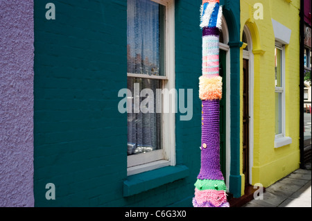 gestrickte Ärmel um einen Laternenpfahl vor Multi farbige Terrasse beherbergt Southsea England uk Stockfoto