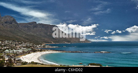 Die Bucht von Camps Bay mit Touristen, die sauberen, weißen Sand und kalte blaue Meer genießen. Stockfoto