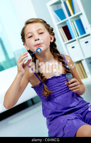 Porträt von netten Mädchen bläst Seifenblasen Stockfoto