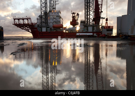 Ein Aufbocken Lastkahn auf Mostyn-Hafen und Wind-Turbine-Teile. Stockfoto