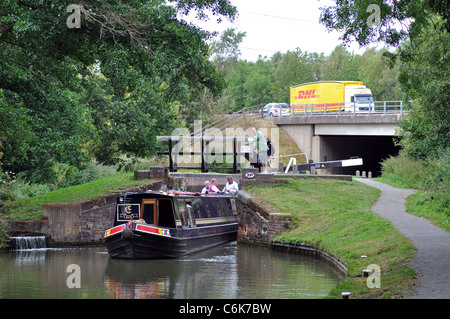 Narrowboat am Stratford-Kanal mit einem DHL-LKW auf der Autobahn M40 hinter, Warwickshire, UK Stockfoto