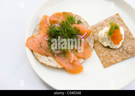 Knuspriges Brot, belegt mit geräuchertem Lachs und frischem Dill, saurer Sahne und Lachsrogen Stockfoto