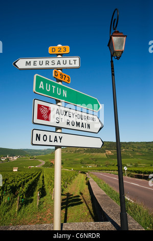 Schild am Eingang zum Dorf Meursault mit Weinbergen und das Dorf von Auxey-Duresses in der Ferne Stockfoto