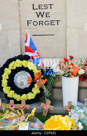 Kränze und andere Gegenstände auf dem Boden herum Royal Wootton Bassett Kriegerdenkmal links. Stockfoto