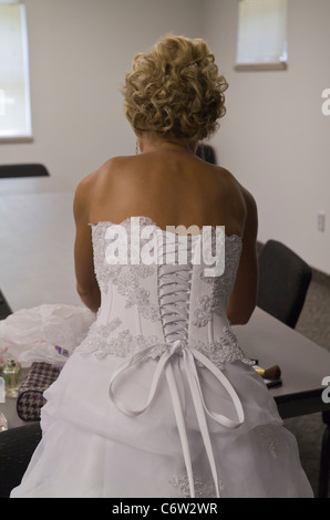 Die Braut in einem weißen Kleid bereitet sich auf die Hochzeit vor, die hinten hochauflösende Nahaufnahme Stockfoto