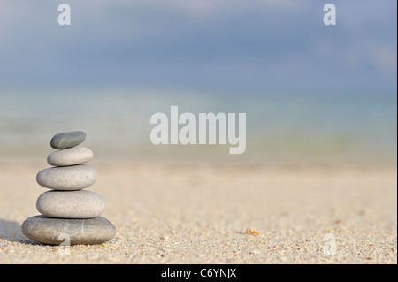 Stapel von Kieselsteine am Strand, von einem tropischen Meer Stockfoto