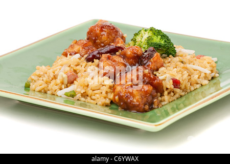 Ein Teller mit General Tsos Huhn mit Brokkoli und Schweinefleisch gebratener Reis isoliert auf einem weißen Hintergrund. Stockfoto