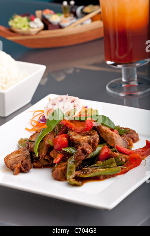 Ein frisches Gericht der Thai-Stil Chile Basilikum Ente mit gemischtem Gemüse weiße klebrige Jasminreis und thai Eistee. Stockfoto