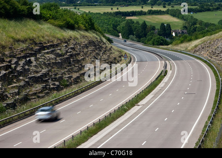 einziges Auto bewegen schnell auf der A417-Schnellstraße in der Nähe von Cirenceter Stockfoto