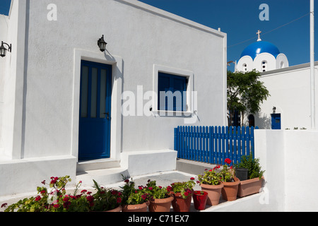 Blaue Kuppel griechische Kirche und weißen Mauern umgebene Haus im Dorf Akrotiri, Santorin, Griechenland Stockfoto