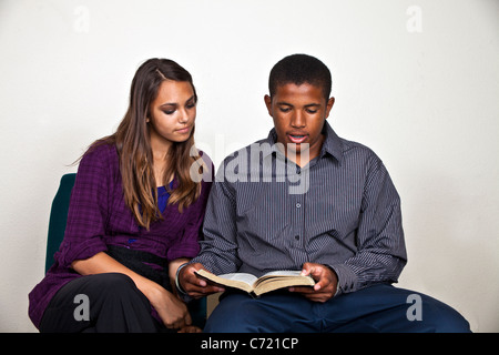 Kalifornien Multi ethnischen Rasse ethnisch African American Boy und hispanischen Mädchen lesen gemeinsam die Bibel. Herr © Myrleen Pearson Stockfoto