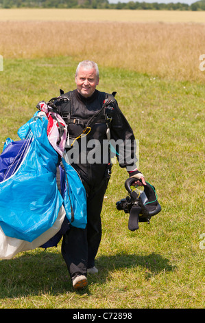 Ein Fallschirm-Jumper mit Kameras an seinem Helm befestigt, der die anderen Springer am Ellough Flugplatz in der Nähe von Beccles in Suffolk, Uk filmt Stockfoto