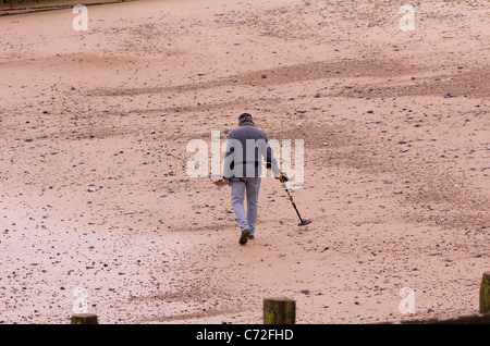 Ein Mann sucht den Strand von Cromer Norfolk mit Metall detecor Stockfoto