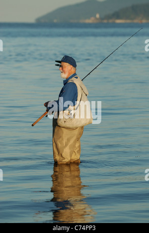 Freizeitsport Fischer stehend in das Salzwasser des Burrard Inlet Angeln auf Lachs. Stockfoto