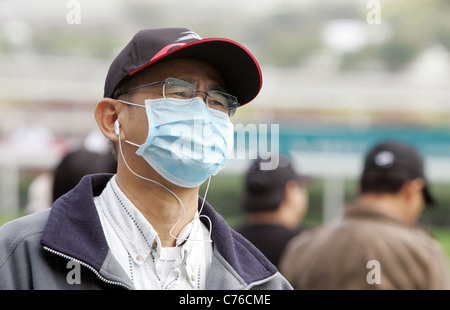 Mann mit Basecap und eine Maske Hong Kong China Stockfoto