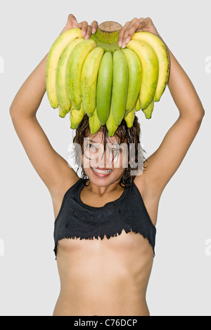 Fröhliche Mädchen hält ein Bündel Bananen Stockfoto