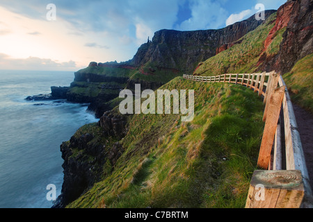 Eingezäunten Cliffside Trail auf Benbane Head in der Nähe von Sonnenuntergang, Giant es Causeway, County Antrim, Nordirland, Vereinigtes Kingdon Stockfoto