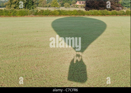 Schatten der Heißluftballon auf Feld, Menschen, die im Warenkorb sichtbar. Stockfoto