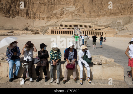 Japanische Touristen tragen chirurgische Gesichtsmasken am Tempel der Hatschepsut, Luxor, Ägypten Stockfoto