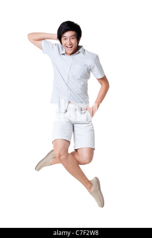 Junger Mann In die Luft springen Stockfoto