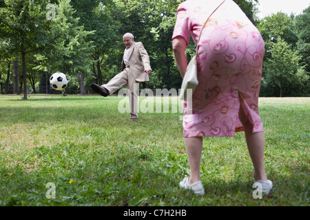 Älteres Paar spielen Fußball im park Stockfoto