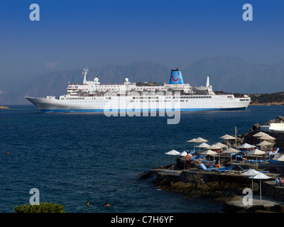 Das Kreuzfahrtschiff Thomson Spirit verlassen den Hafen von Agios Nikolaos auf der griechischen Insel Kreta von Urlaubern beobachtet. Stockfoto