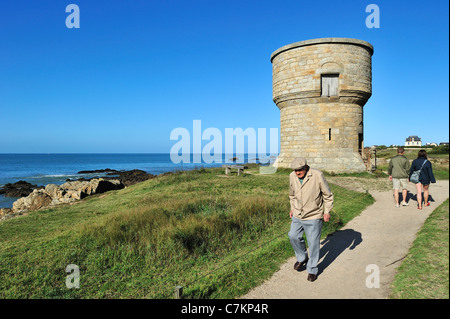 Touristen zu Fuß entlang der alten Wachturm entlang der Côte Sauvage in der Nähe von Le Croisic, Loire-Atlantique, Pays De La Loire, Frankreich Stockfoto