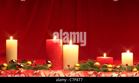 Brennende Kerzen in einem Weihnachts-Ambiente mit Saisondekorationen. Stockfoto